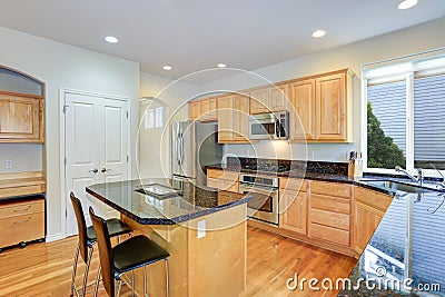 Sun filled gourmet kitchen with wooden cabinetry Stock Photo