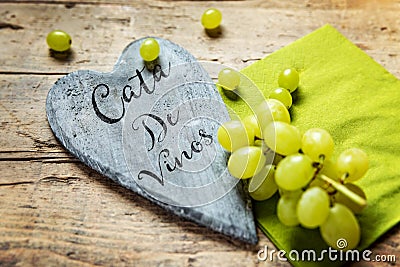 White grapes on wooden table, wooden heart with spanish text Stock Photo