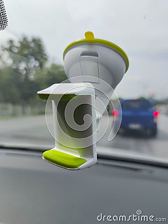 White green blank smartphone holder stuck in the windscreen of a car Stock Photo