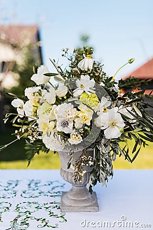 White and green variety of flowers in a large central table bouquet Stock Photo