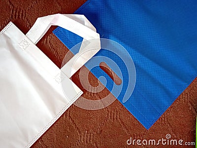 White handle loop bag, Blue color d cut bag, Non Woven Bags Stock Photo