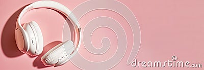 White headphones, pastel pink background, copyspace for text - blank space, banner, music concept, digital ai Stock Photo
