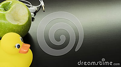 White headphones, a yellow duck and a green apple Stock Photo