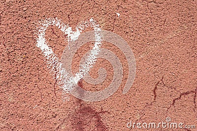 White heart drawn on a red cracked wall Stock Photo