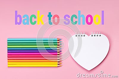 White heart shaped notepad pastel colors pencils Stock Photo
