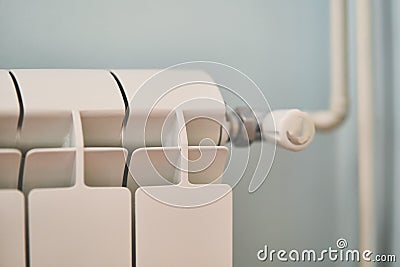 White heating metal radiator with a pipe close up Stock Photo