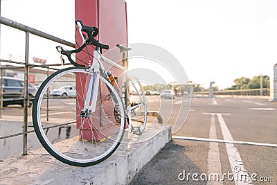 White highway bike on the background of street parking for cars. Ecological transport Stock Photo