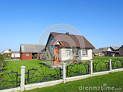 White home and metallic fence , Lithuania Editorial Stock Photo