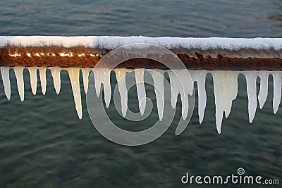 White icicles on a pipe Stock Photo