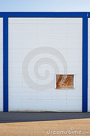 White Industrial warehouse wall in blue frame. Stock Photo