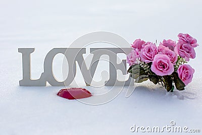 White inscription love in the snow in winter. Stock Photo