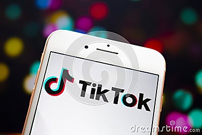 A white iPhone Plus with the TikTok logo on the screen Editorial Stock Photo