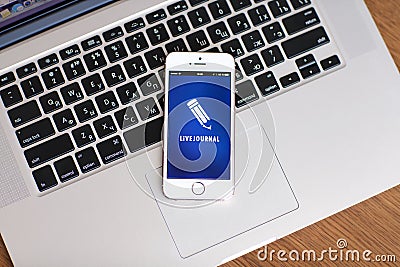 White iPhone 5s with site LiveJournal on the screen lies on the Editorial Stock Photo