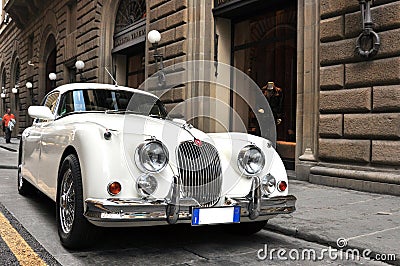 White Jaguar retro car on the streets of Italy Editorial Stock Photo