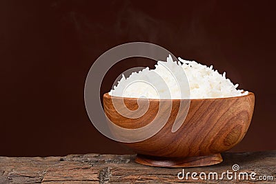 Hot rice in wooden bowl Stock Photo