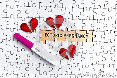 White jigsaw puzzle with ectopic pregnancy word over orange background. Stock Photo