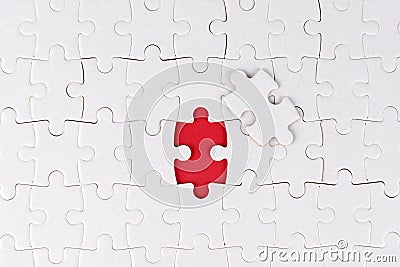 White jigsaw puzzle with missing piece on red. Business concept. White jigsaw puzzle with two missing pieces on red. Stock Photo