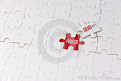 White jigsaw puzzle with missing piece on red with text. Business concept. Problem solved. Team work and solution Stock Photo