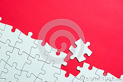 White jigsaw puzzle on red background Stock Photo