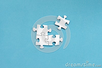 White jigsaw puzzles, on blue background Stock Photo