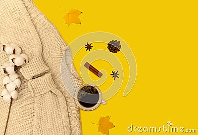 White jumper on a yellow background. White branch of cotton. A cup of coffee. Stock Photo