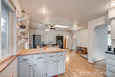 White kitchen wood countertop wooden floor white ceiling modern real estate family house Stock Photo