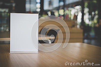 white label in cafe. display stand for acrylic tent card in coffee shop. mockup menu frame on table in bar restaurant. Stock Photo