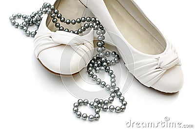 White ladies shoes with silver pearl necklace Stock Photo