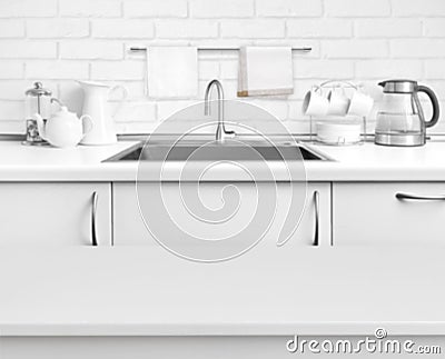 White laminated table on blurred rustic kitchen sink interior background Stock Photo