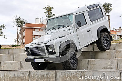 White Land Rover Defender off-road jeep on concrete stairways during an exhibition in a park Editorial Stock Photo