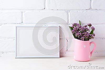 White landscape frame mockup with purple flowers in polka dot pi Stock Photo