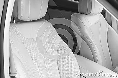 White leather interior of the luxury modern car. Leather comfortable white seats and multimedia. exclusive wood and metal decorati Stock Photo