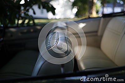 White leather seats in an American convertible under a tree. Stock Photo