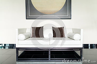 White leather sofa and brown pillow in lounge at living room Stock Photo