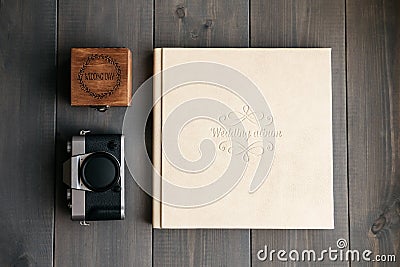 White leather wedding album, wooden box with inscription Wedding day and vintage photo camera Stock Photo