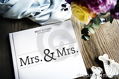 White Lesbian Wedding Guest Book Laid on Wooden Table Stock Photo