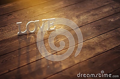 White letters stand on the wooden surface in the warm sun Stock Photo