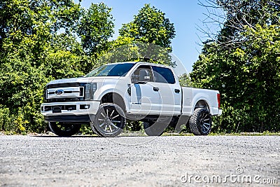 White lifted Ram truck near green trees on a sunny day Editorial Stock Photo