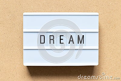 White light box with word dream on wood background Stock Photo