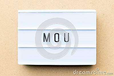 Lightbox with word MOU Abbreviation of memorandum of understanding on wood background Stock Photo