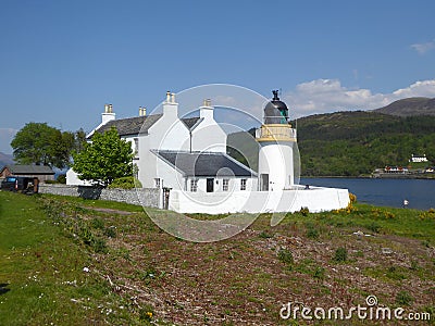 White lighthouse and keeper`s cottages Stock Photo