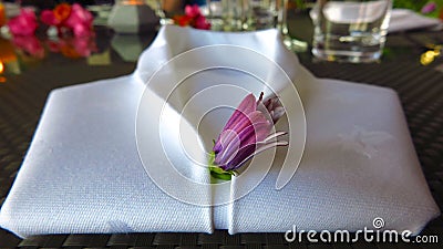 White linen napkin folded into shape of tuxedo shirt Stock Photo