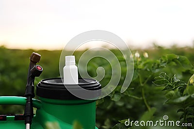 White little bottle of pesticide, herbicide for protecting plants from diseases and pests with mock up stands on Stock Photo