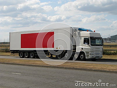 White lorry with red banner Stock Photo