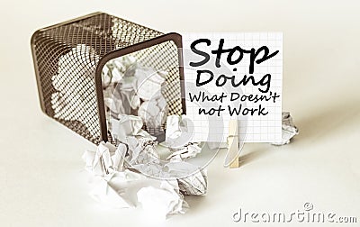 White lumps of paper fall out of the case to the paper in the inscription Stop Doing What Doesn t not Work Stock Photo