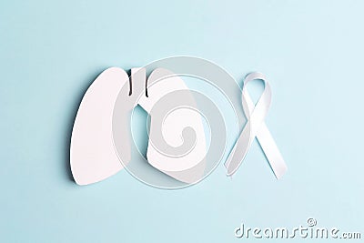 White lung cancer awareness ribbon and lung symbol on blue background Stock Photo