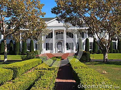 White Mansion with Trees Stock Photo