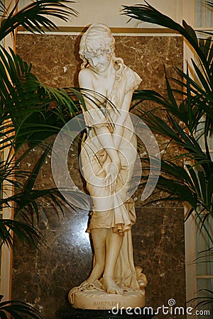 White marble statue of a young girl bathers decorated with beautiful white Banquet hall of the old hotel Astoria. Editorial Stock Photo