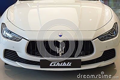 White Maserati Ghibli close up front side view brand logo trident display at showroom dealer at the Siam Paragon Mall in Bangkok, Editorial Stock Photo