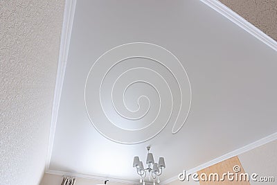 White matte ceiling in a large room close up Stock Photo